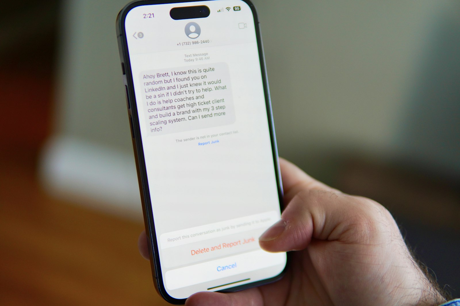 A hand holding an iPhone showing a text message conversation — Photo by Brett Wharton on Unsplash